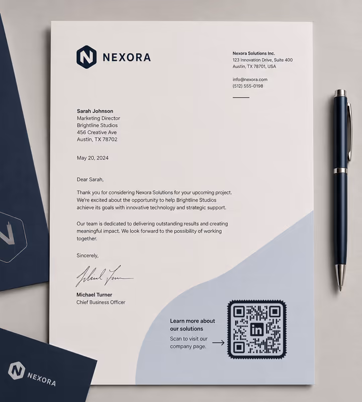 A printed company letter signed at the foot, with a “Scan to visit our company page” panel and a square QR code, a pen lying alongside