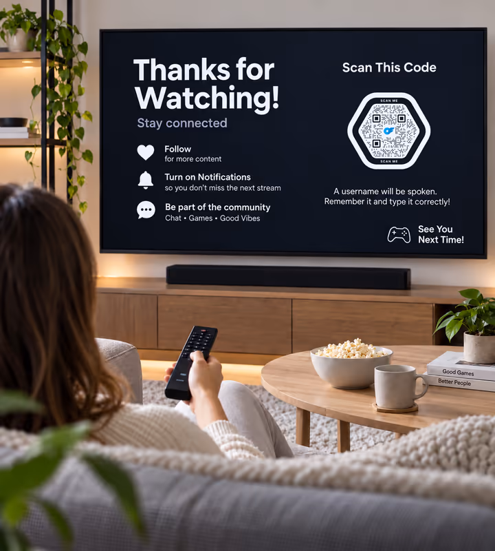 A television showing a “Thanks for watching - stay connected” end screen with a hexagonal QR code, watched from a sofa with a remote in hand