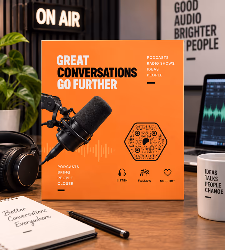 An orange podcast artwork board reading “Great conversations go further” with a hexagonal QR code, on a desk under an on-air sign