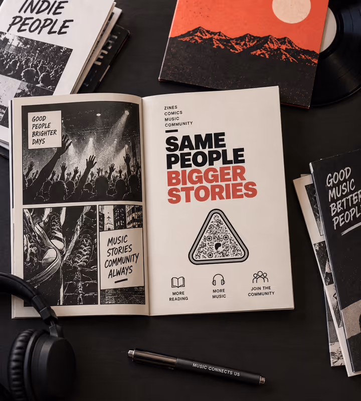 An open zine spread headed “Same people, bigger stories” with a triangular QR code, lying among record sleeves and headphones
