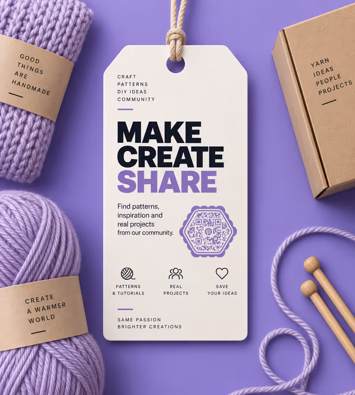 A white “Make, create, share” swing tag with a purple hexagonal QR code, among lilac yarn, wooden needles and a kraft box