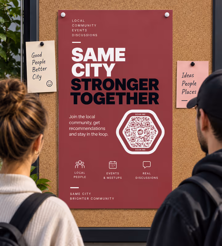 A dark red “Same city, stronger together” poster with a white hexagonal QR code on a cork board, two people reading it