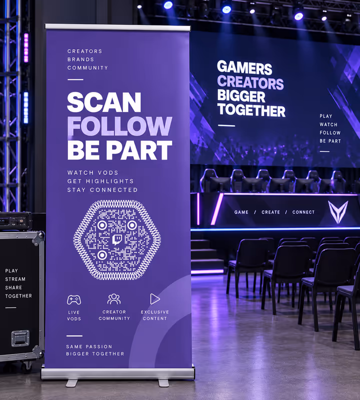 A purple roll-up banner reading “Scan, follow, be part - watch VODs, get highlights” with a hexagonal QR code, in an esports arena with empty seats