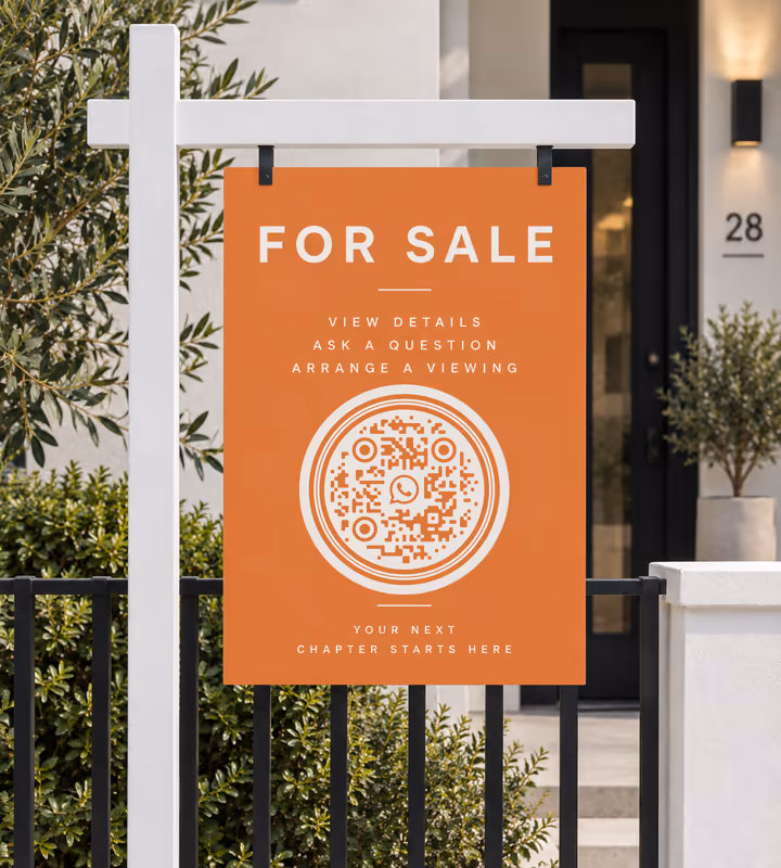 An orange “For sale - view details, ask a question, arrange a viewing” board with a white circular QR code, on a post outside a house