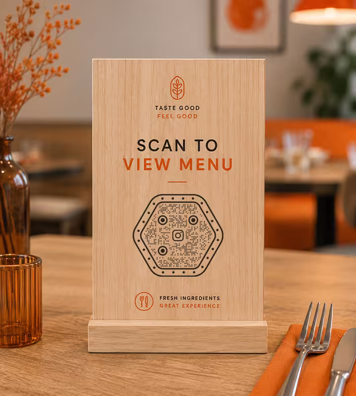 A wooden “Scan to view menu” table sign with a hexagonal QR code, standing on a restaurant table