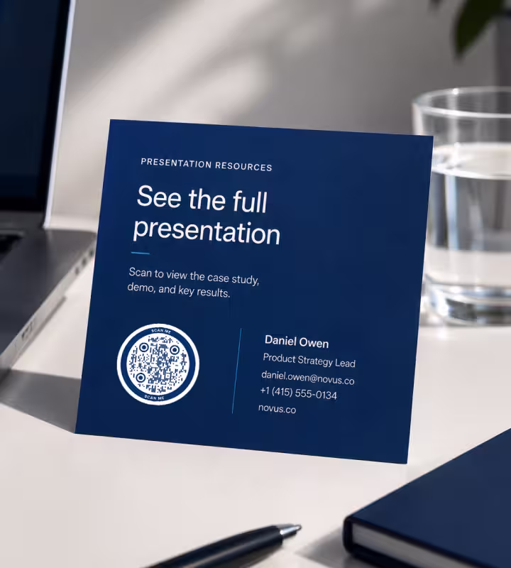A navy presentation card reading “See the full presentation” with a QR code on a desk