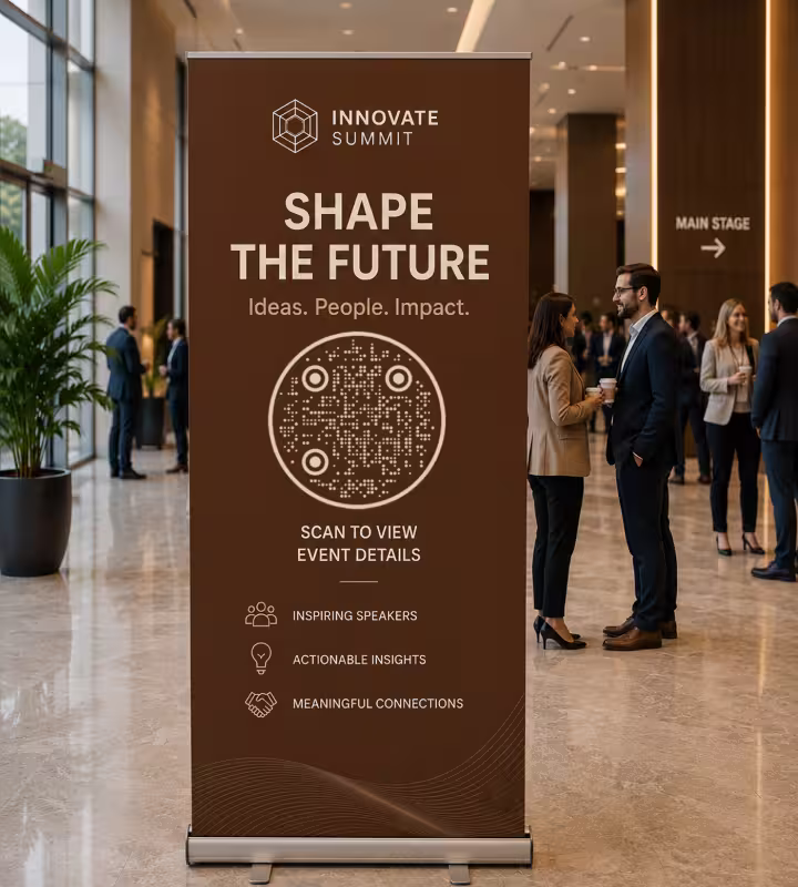A pull-up banner in a conference lobby reading “Shape the future” with a round QR code marked “Scan to view event details”